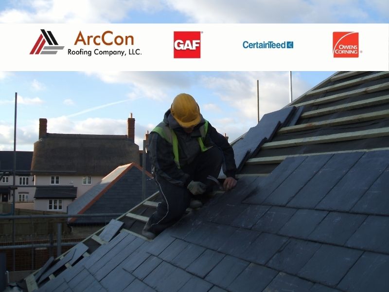 Man working to install slate roofing